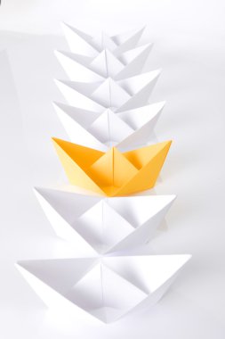 Yellow paper boat in queue clipart