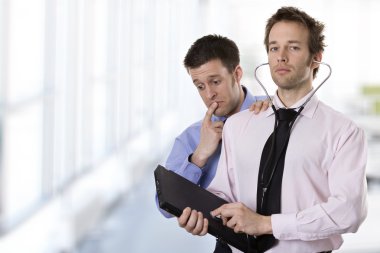 A doctor analyzing a laptop with a steth clipart