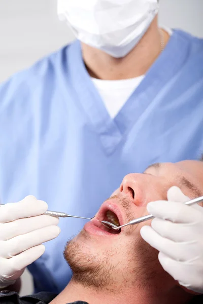 Handsome young man visiting dentist — Stock Photo, Image