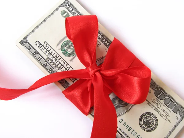Money with bow of red ribbon — Stock Photo, Image