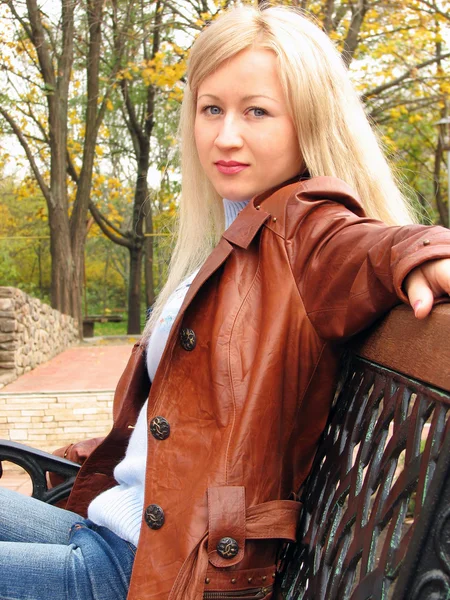 stock image Pretty girl in jacket, sitting