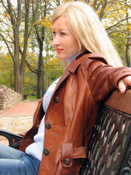 stock image Pretty girl in jacket, sitting