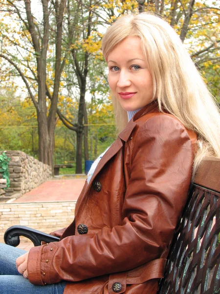 stock image Pretty girl in jacket, sitting