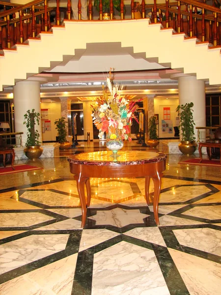Стол с цветами в холле отеля — стоковое фото