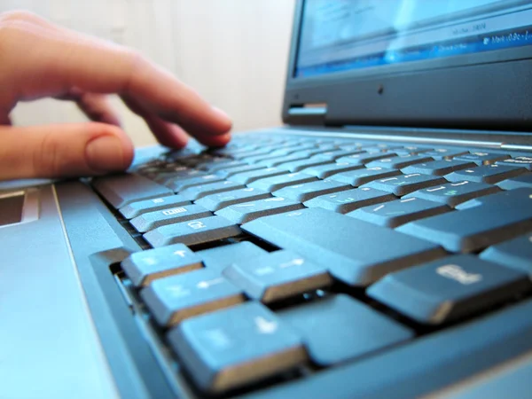 Laptop keyboard with human hand — Stock Photo, Image