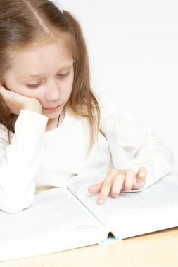 Child reading a book clipart