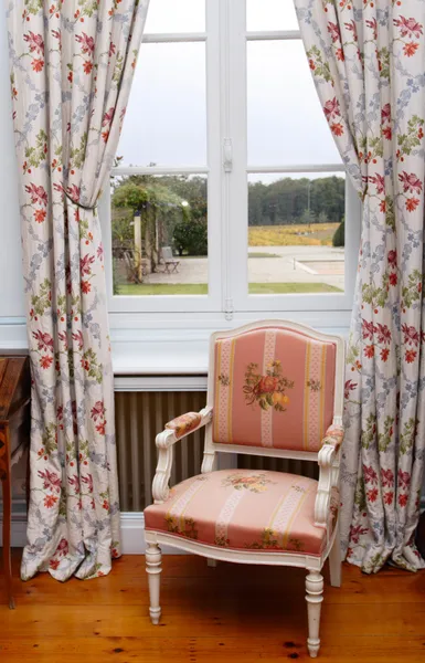 Armchair close to window — Stock Photo, Image