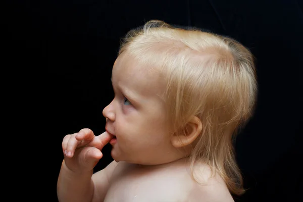 Portret van een baby op een donkere achtergrond — Stockfoto