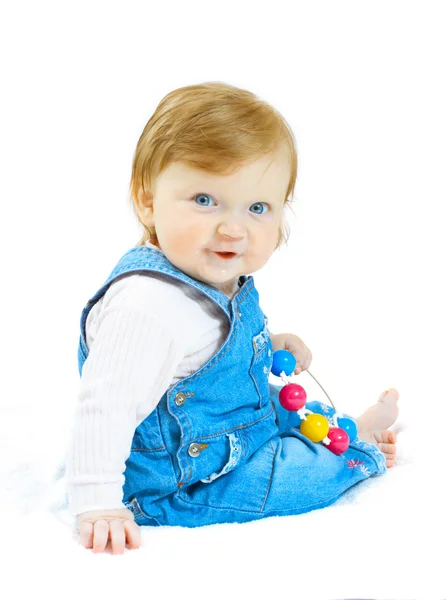 Ребенок в джинсовом костюме с игрушкой — стоковое фото