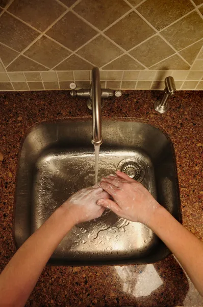 Overview of hand washing over a sink — Stock Photo, Image