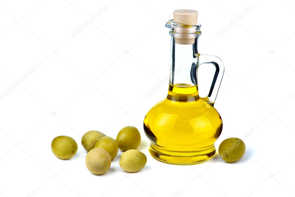 Decanter with olive oil and olives near