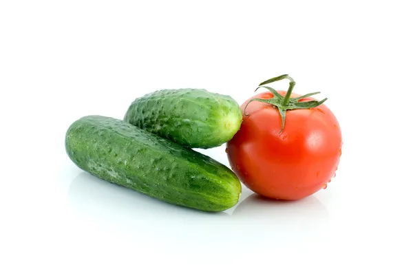 Single tomato and pair of cucumbers — Stock Photo, Image