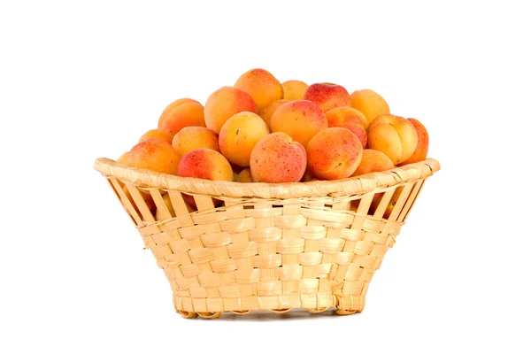 Wicker basket filled with apricots — Stock Photo, Image