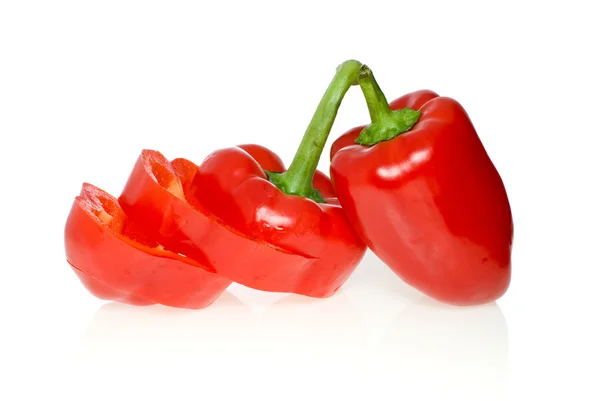 Sliced and whole red sweet peppers — Stock Photo, Image