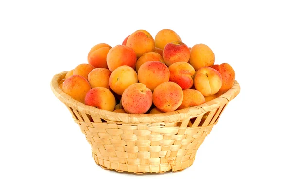 Stock image Wicker basket filled with apricots