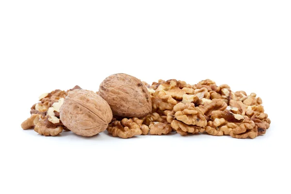 Two walnuts and some kernels — Stock Photo, Image