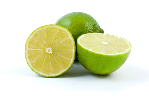 Limes. Whole and halves — Stock Photo, Image