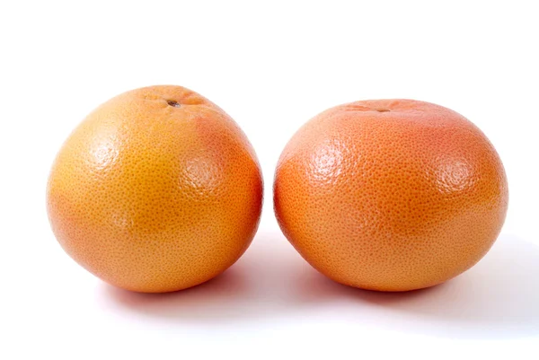 Два апельсиновых грейпфрута — стоковое фото