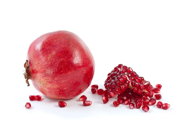 Whole pomegranate\ piece and some beries — Stock Photo, Image