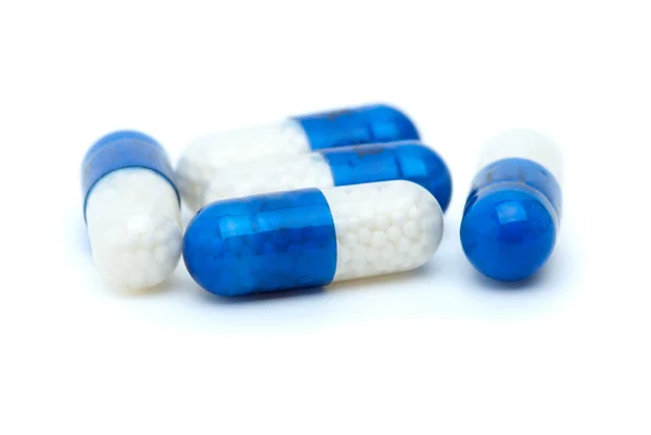Vier weiß-blaue Pillen — Stockfoto