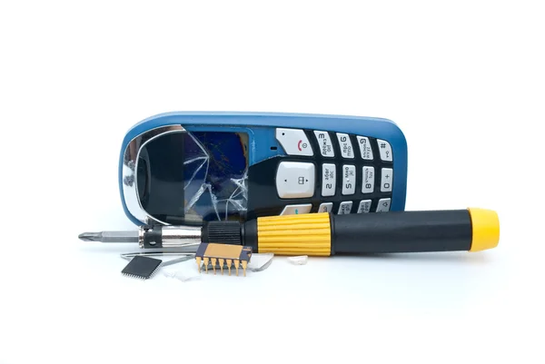 Broken mobile phone, screwdriver and microchips — Stock Photo, Image
