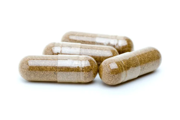 Vier homöopathische braune Pillen — Stockfoto