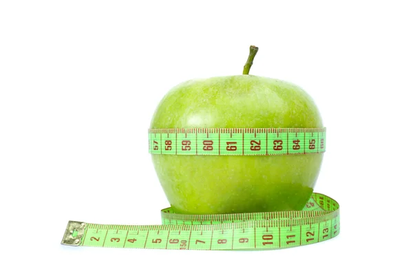 Зеленое яблоко и измерительная лента — стоковое фото