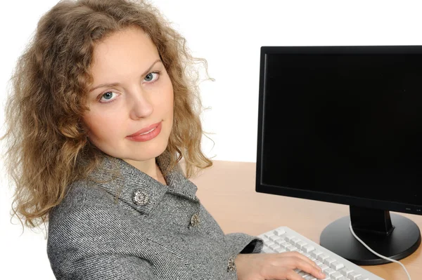 Woman smiling in front of her computer — Stock Photo, Image