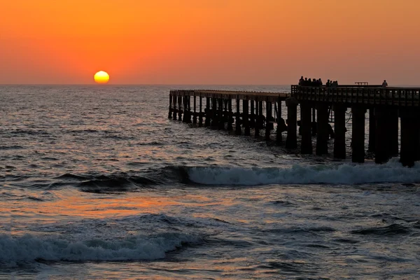 stock image Silhouetted coastal pier