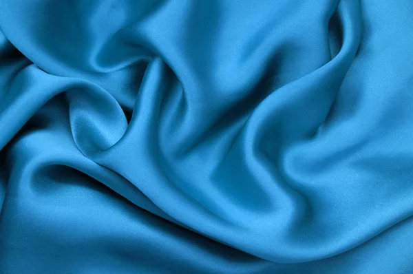 Синий атласный текстильный фон — стоковое фото