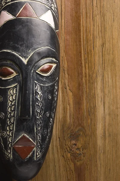 African mask over wooden background — Stock Photo, Image