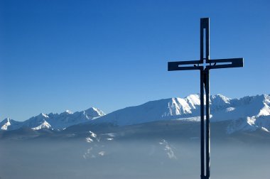 Cross on the top of a mountain clipart