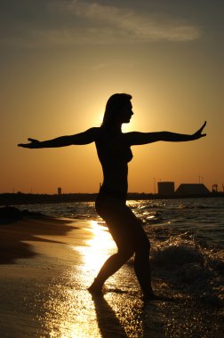 Sunset Tai-Chi on a beach clipart