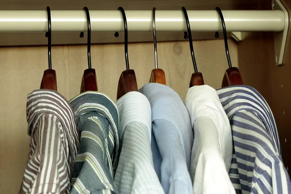 Shirts hanging in the wardrobe — Stock Photo, Image