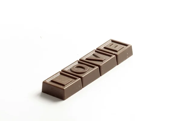 Woord liefde gemaakt van kleine chocolade — Stockfoto