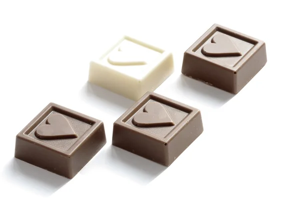 Four chocolates with the little hearts — Stock Photo, Image