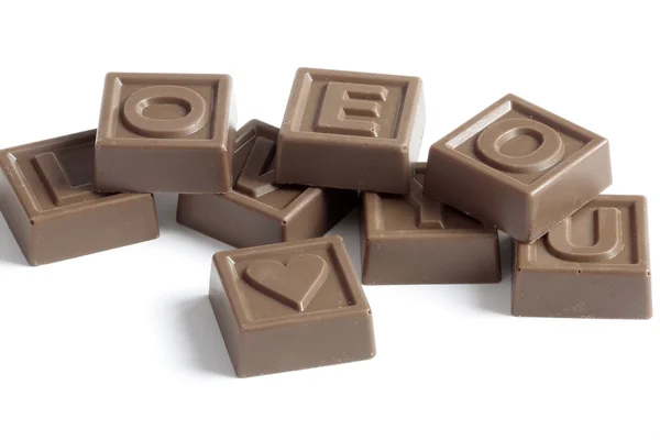 Quebra-cabeças de chocolate com palavra amor — Fotografia de Stock