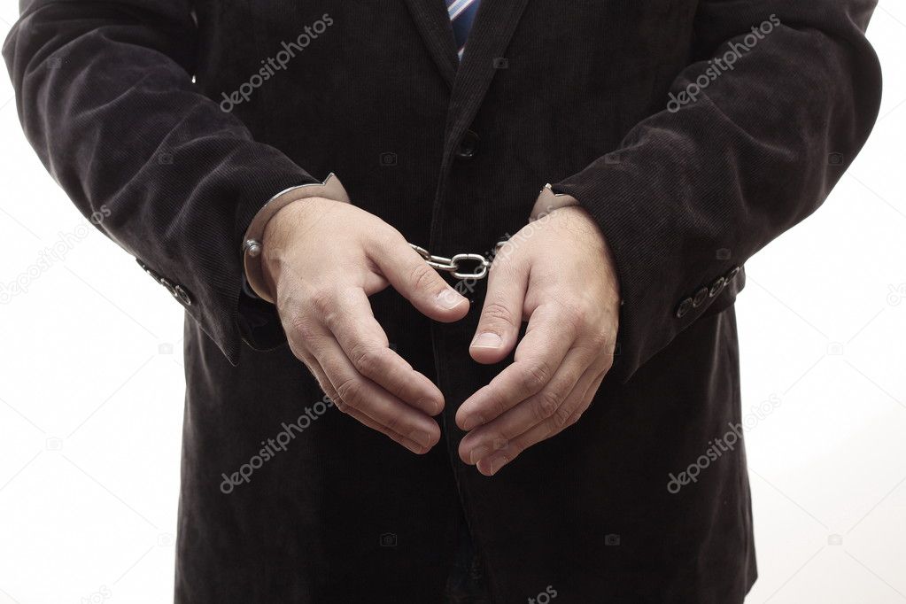 Businessman chained in handcuffs