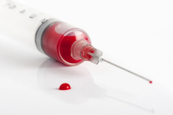 Syringe with blood Stock Image