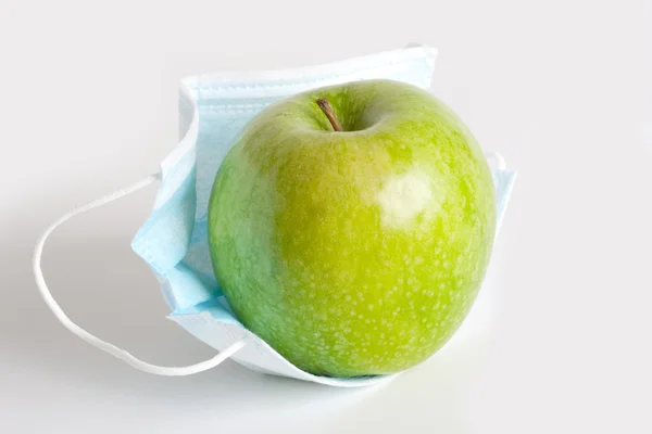 Apfel in der Maske Stockfoto