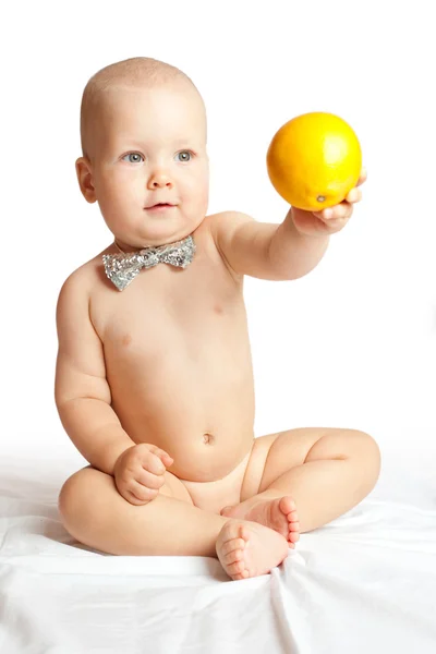 Kind mit Orange Stockfoto