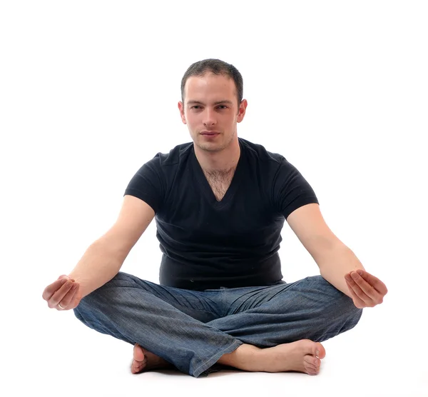 Joven en posición de loto ejerciendo yoga —  Fotos de Stock