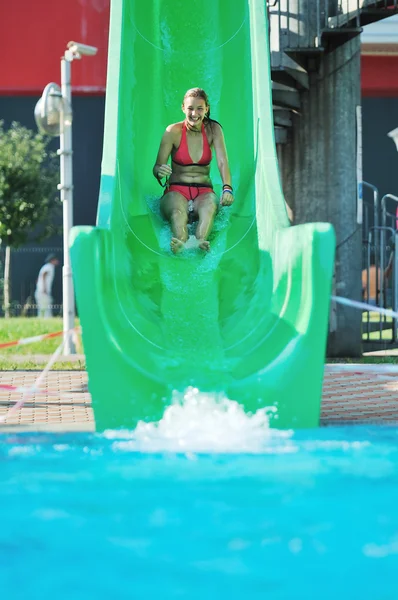 Girl have fun on water slide at outdoor swimmin — Stock Photo, Image