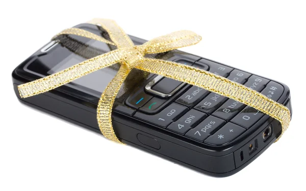 Black mobile phone with gold ribbon — Stock Photo, Image