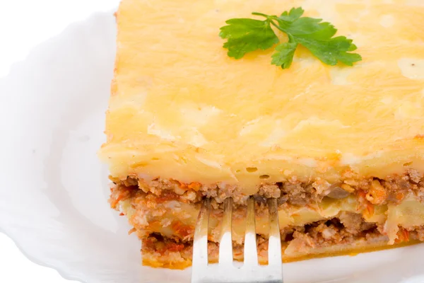 Close-up lasagne on plate with fork — Stock Photo, Image