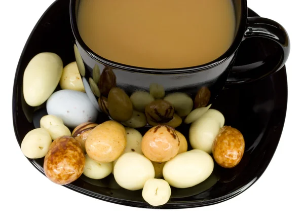 Coffee cup with milk and candies — Stock Photo, Image