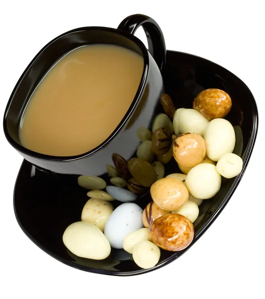 Cup of coffee with milk and candies — Stock Photo, Image