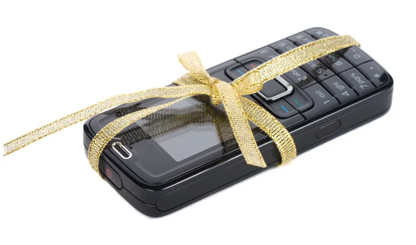 New black mobile phone with gold ribbon — Stock Photo, Image