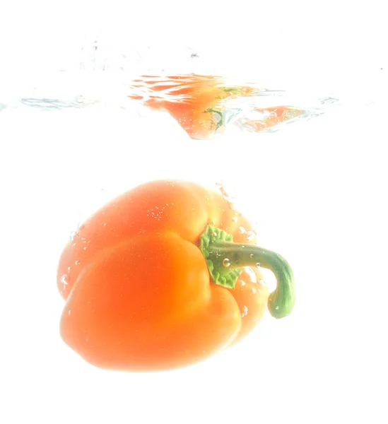 Pepper falling in water — Stock Photo, Image