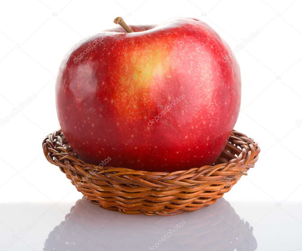 Red apple in basket with reflection